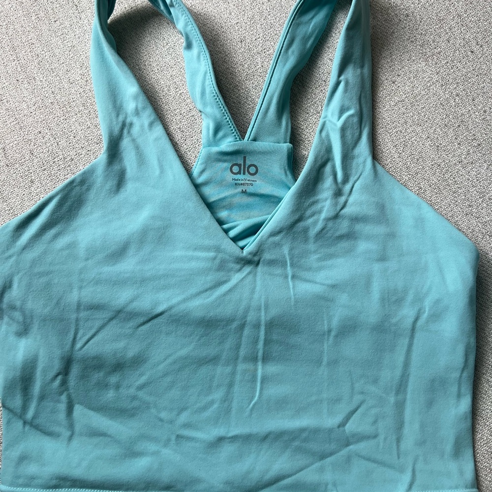 ALO Yoga Teal Sports Bra RN #87370. New. Was in vacuum sealed bag.